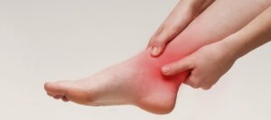Woman suffering from pain in ankle closeup